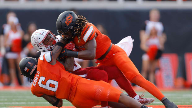 Sep 16, 2023; Stillwater, Oklahoma, USA; Oklahoma State Cowboys safety Lyrik Rawls (6) and Oklahoma State Cowboys safety Kendal Daniels (5) bring down South Alabama Jaguars wide receiver Caullin Lacy (4) during an NCAA football game between Oklahoma State and South Alabama at Boone Pickens Stadium. South Alabama won 33-7. Mandatory Credit: Bryan Terry-USA TODAY Sports